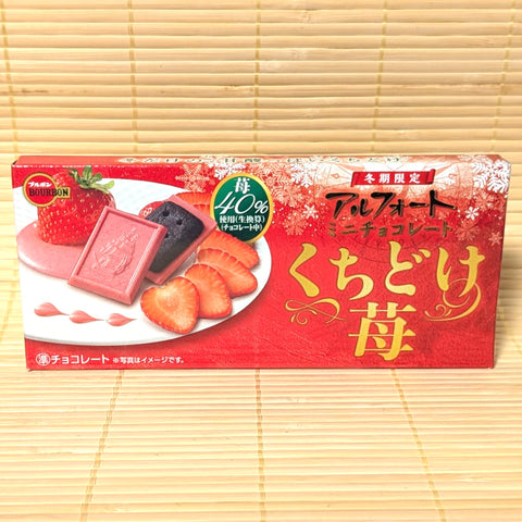 A slim box of Bourbon Alfort Kuchidoke rich strawberry chocolate. Displayed on a tatami background.