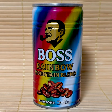 A colorful rainbow-striped can of Suntory BOSS Rainbow Mountain Blend coffee with the iconic pipe-smoking logo, on a Japanese tatami background.