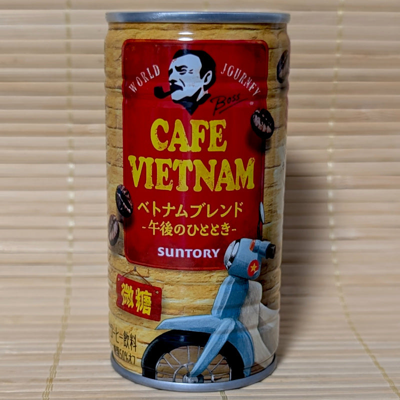 A can of BOSS Café Vietnam can with a miniature scooter graphic. Displayed on a wooden surface