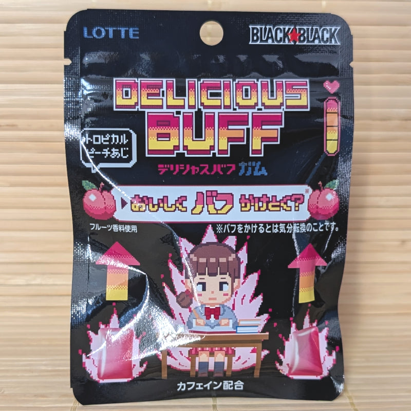 A black 21g pouch of Lotte Black Black Delicious Buff Tropical Peach Gum featuring retro pixel art of a powered-up student at a desk on a bamboo mat background.