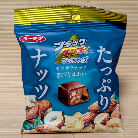 A pack of Black Thunder Chocolate: Tappuri Nuts Mix. The Mini Bites are displayed on a tatatmi background.