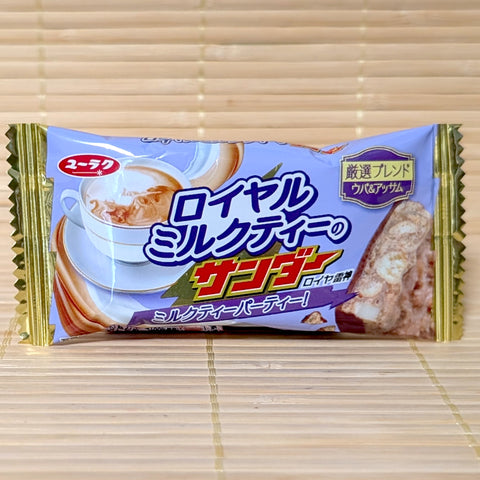 A lavender packaging of Black Thunder Royal Milk Tea bar featuring a hot teacup illustration and chocolate cross-section on a bamboo background.