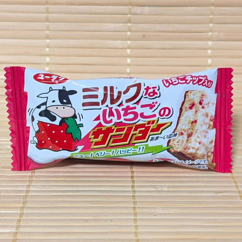 A Black Thunder strawberry milk mini chocolate bar on a bamboo mat background