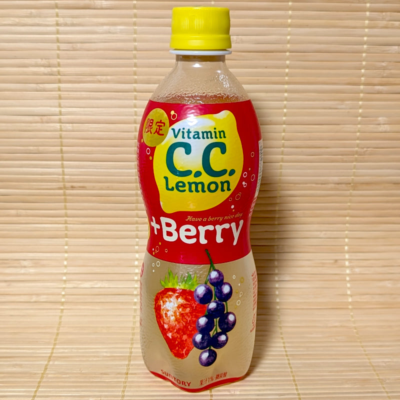 A 500ml bottle of Suntory C.C. Lemon +Berry Soda showing strawberry and blueberry graphics on a red label against a bamboo background.
