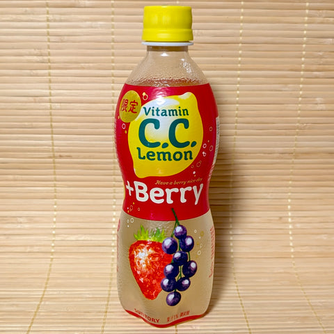 A 500ml bottle of Suntory C.C. Lemon +Berry Soda showing strawberry and blueberry graphics on a red label against a bamboo background.
