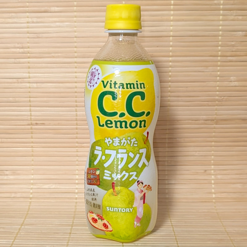 A 500ml plastic bottle of Vitamin C.C. Lemon La France Pear Mix with green pear graphics on a bamboo background.