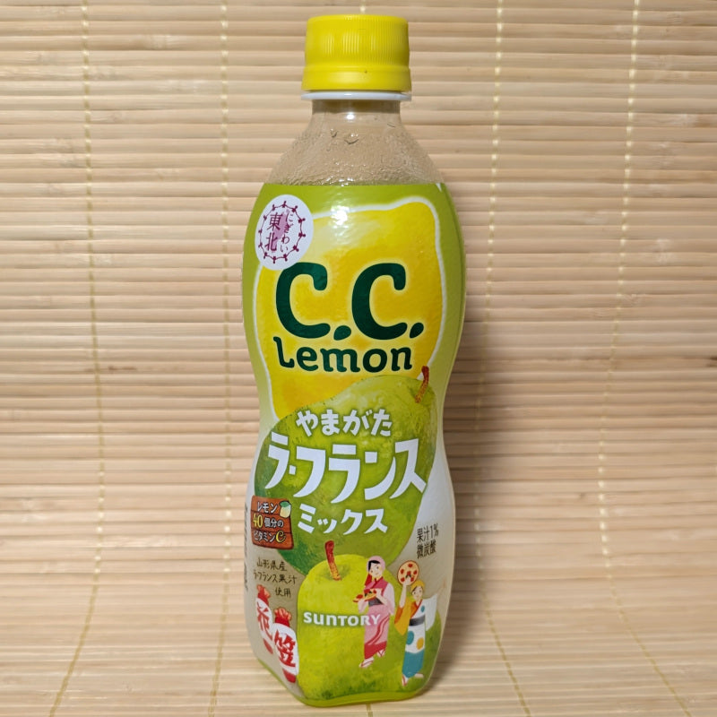 A C.C Lemon bottle of PEAR MIX with yellow cap displayed on a wooden surface