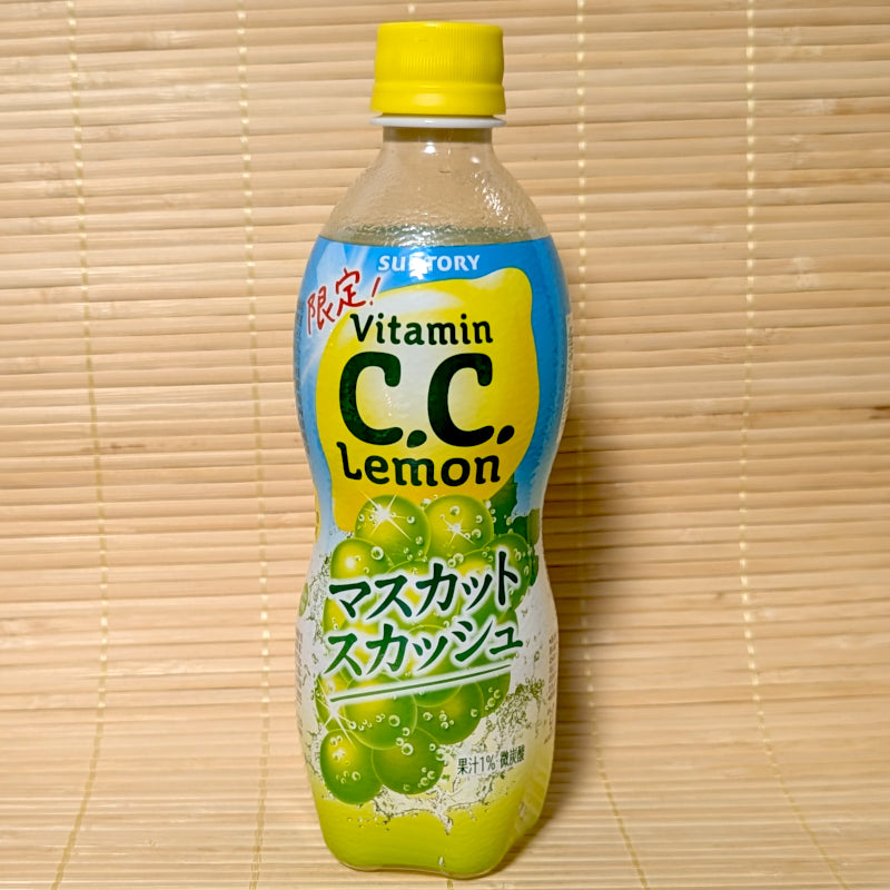 A 500ml bottle of Vitamin C.C. Lemon Muscat Squash Soda with green Muscat grape graphics, resting on a bamboo mat.