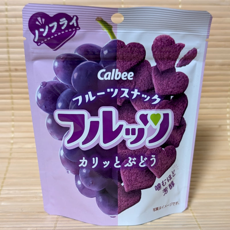 A light purple resealable pouch of Calbee Grape Fruit Snacks showing heart-shaped purple chips and a grape cluster, on a tatami background.