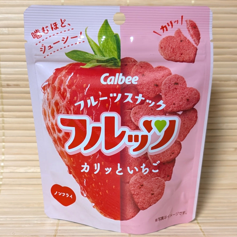 A Calbee freeze dried strawberry cracker chips in a heart shape. The package is displayed on a tatami surface