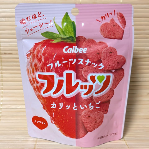 A Calbee freeze dried strawberry cracker chips in a heart shape. The package is displayed on a tatami surface