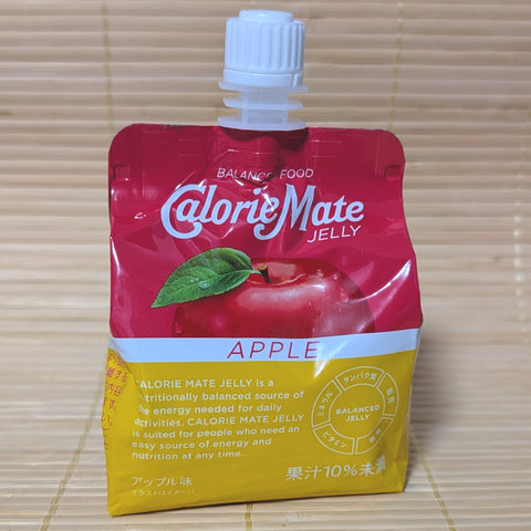 A red and yellow squeezable pouch of Calorie Mate Jelly Apple flavor featuring a fresh red apple illustration. Displayed on a tatami background.