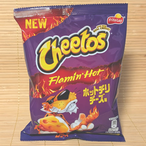 A metallic purple bag of Japanese Cheetos Flamin' Hot Chili Cheese showing Chester Cheetah and a fiery cheese slice on a tatami background.
