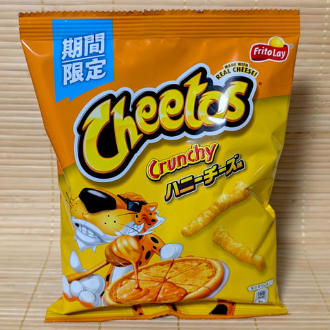 Limited Edition Japanese Cheetos bag in Honey Cheese flavor with Chester Cheetah displayed on a tatami background.