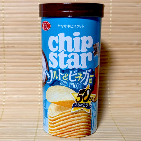 A light blue 45g cardboard canister of YBC Chip Star Salt & Vinegar potato chips with 50th anniversary logo on a bamboo mat background.