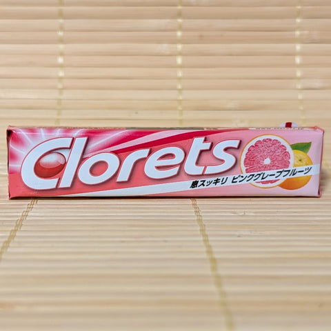 Pack of Clorets candy with pink grapefruit flavor on a wooden surface