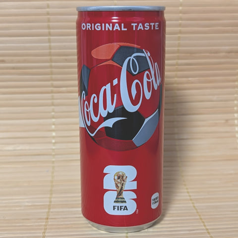 A sleek 250ml red Coca-Cola can featuring a soccer ball graphic and the FIFA World Cup 2026 logo, photographed on a traditional Japanese tatami background.