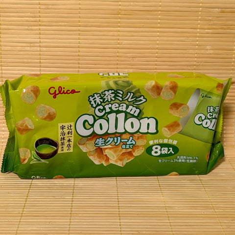 A green bag of Glico Cream Collon Matcha Milk with 8 individual packs on a bamboo mat background.