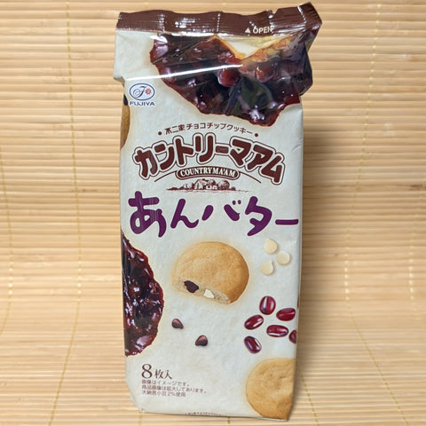 A white and brown bag of Fujiya Country Ma'am Anko Butter cookies showing red beans, butter, and a cross-section of a cookie, on a tatami background.