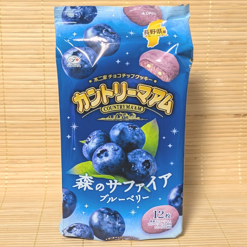 A vibrant blue bag of limited edition Fujiya Country Ma'am Mori no Sapphire Blueberry cookies showing fresh berries on a tatami background.