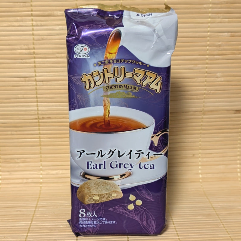 Box of Fujiya Country Ma'am Earl Grey Tea cookies featuring an elegant tea-themed design. Displayed on a tatami background.