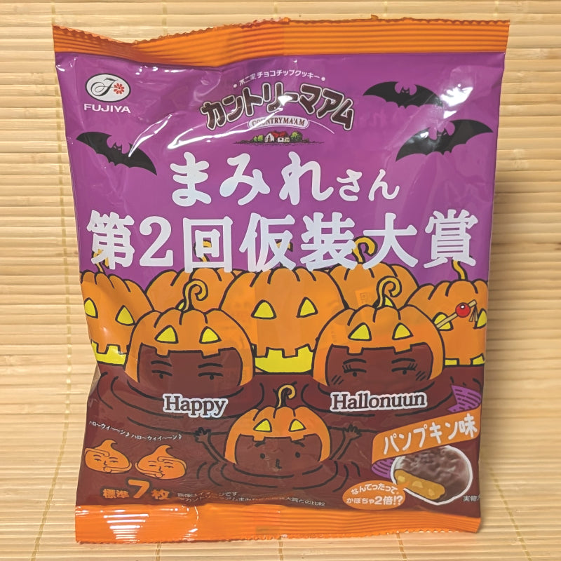 A purple and orange 70g bag of Fujiya Country Ma'am Choco Mamire Halloween Pumpkin cookies with jack-o'-lantern illustrations on a bamboo mat.