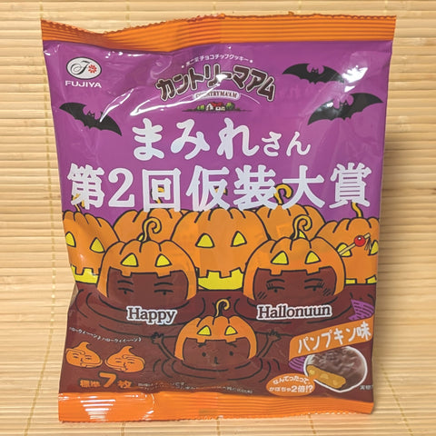 A purple and orange 70g bag of Fujiya Country Ma'am Choco Mamire Halloween Pumpkin cookies with jack-o'-lantern illustrations on a bamboo mat.