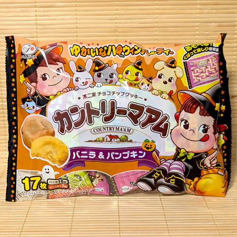 An orange and black Halloween party bag of Fujiya Country Ma'am Vanilla and Pumpkin cookies showing Peko-chan on a bamboo mat background.