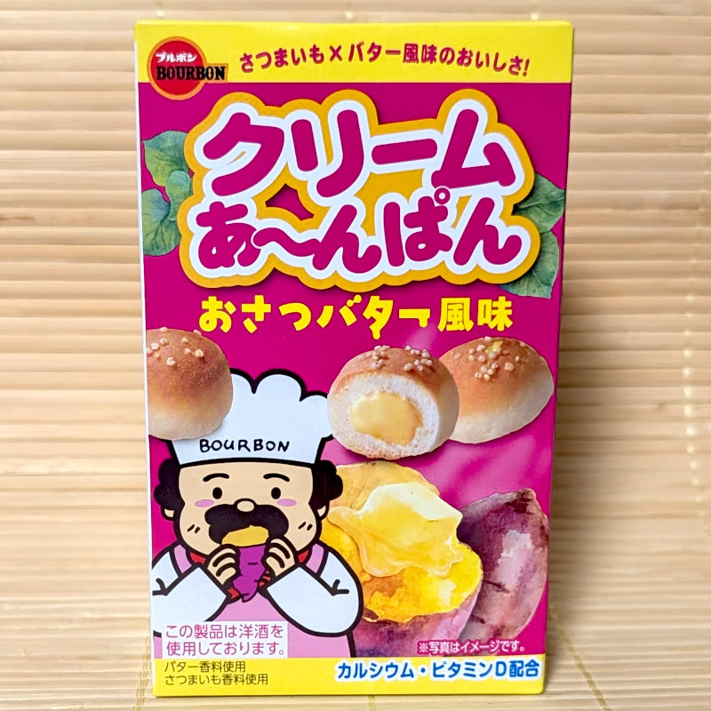 A bright pink and yellow 38g box of Bourbon Cream Ah-Pan Sweet Potato Butter mini bread snacks displaying baker mascot and baked sweet potato artwork on a bamboo mat background.