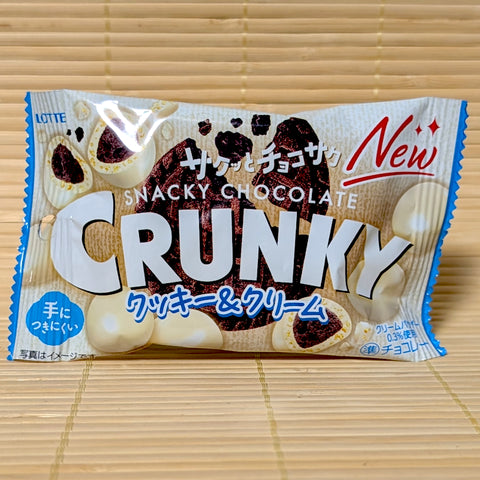 A pack of Crunky Snacky Chocolate Cookies and Cream Balls displayed on a tatami background.