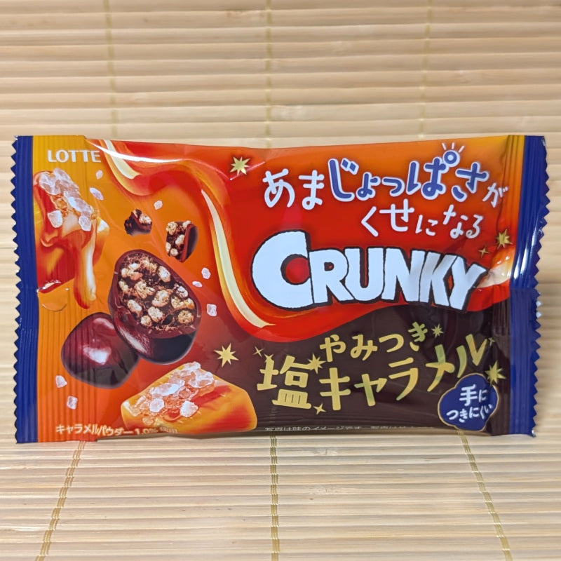 A LOTTE Crunky candy package of salty caramel chocolate balls on a tatami surface.