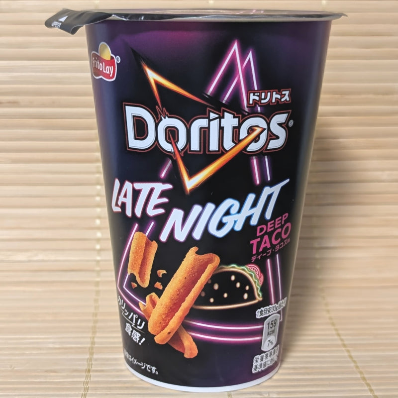 A black and purple neon-styled snack cup of Doritos Cup Style Late Night Deep Taco showing curled orange corn sticks on a tatami background.