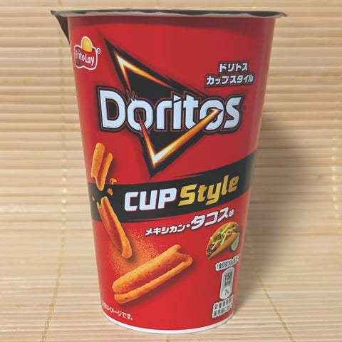 A deep red Doritos Cup Style container featuring S-curled corn sticks and a taco graphic, photographed on a traditional Japanese tatami background.