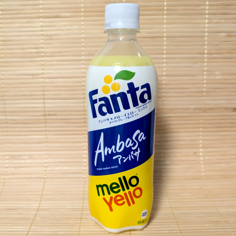 A 500ml plastic bottle of limited edition Fanta Ambasa x Mello Yello Mix showing the blue Ambasa logo and yellow Mello Yello logo on a tatami background.