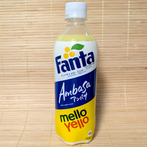 A 500ml plastic bottle of limited edition Fanta Ambasa x Mello Yello Mix showing the blue Ambasa logo and yellow Mello Yello logo on a tatami background.