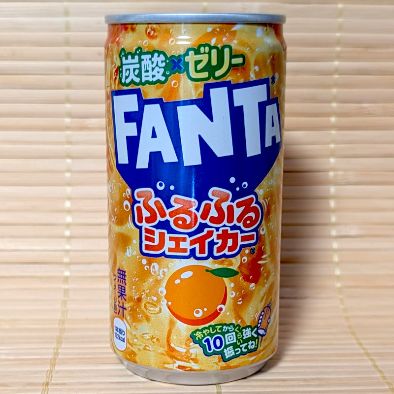 A stubby 180ml can of Japanese Fanta Furu Furu Shaker Sparkling Orange Jelly soda on a bamboo mat.