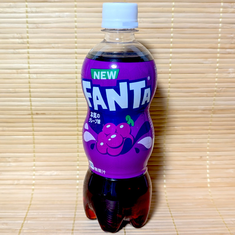 A 500ml bottle of Fanta Grape on a tatami background featuring the "NEW" green banner and "Honki no Grape" Japanese text.