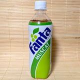 A 490ml plastic bottle of limited edition Fanta Muscat green grape soda featuring a white and green retro vintage style label on a tatami background.