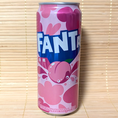 A Fanta White Peach pink tall can with blue logo on a tatami surface.