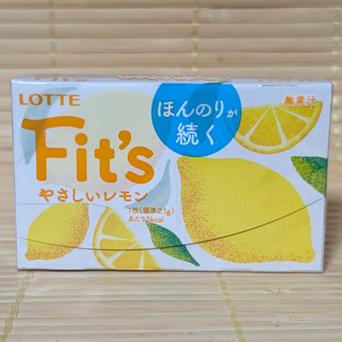A white and yellow pack of Lotte Fit's Yasashii Lemon gum featuring soft yellow lemon illustrations. The item is displayed on a tatami background.