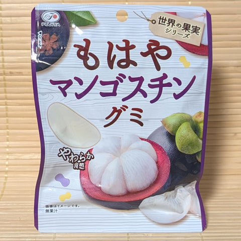 A purple and white 53g pouch of Fujiya Mohaya Mangosteen Soft Gummy showing sliced mangosteen fruit and white segment gummies on a bamboo background.   