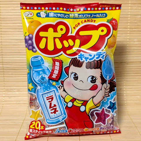 A yellow and red bag of Fujiya POP Candy featuring Peko-chan and a Ramune soda bottle graphic, photographed on a Japanese tatami background.