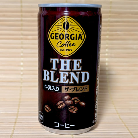 Can of Georgia Coffee 'The Blend' on a wooden surface