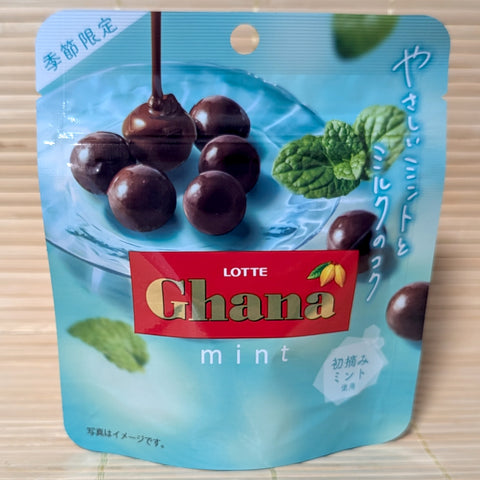 A sky blue resealable pouch of Lotte Ghana Mint chocolate balls showing glossy round candies on a tatami background.