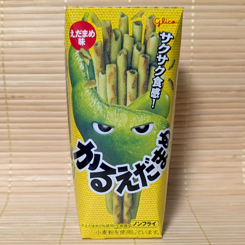 A yellow 36g box of Glico Karuedamame potato sticks featuring a green edamame pod character with eyes against a textured tatami background.