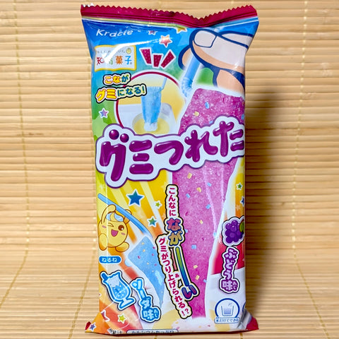 A bright 19g pack of Kracie Gumi Tsureta DIY Candy Kit featuring updated packaging graphics and grape soda gummies on a bamboo mat.