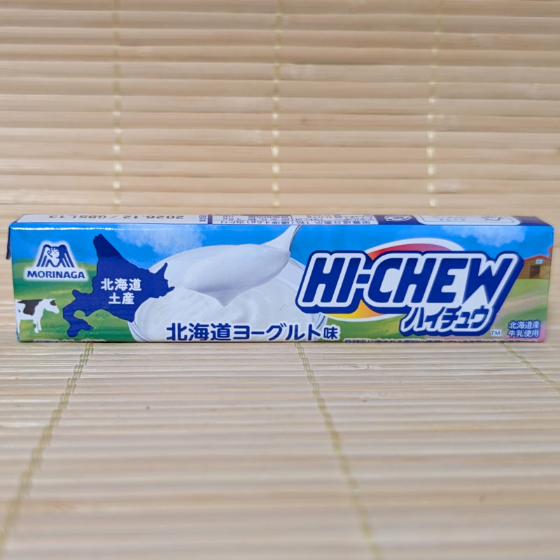 A blue and white 12-piece pack of Hi-Chew featuring a map of Hokkaido and a swirl of fresh yogurt. Displayed on a tatami background.