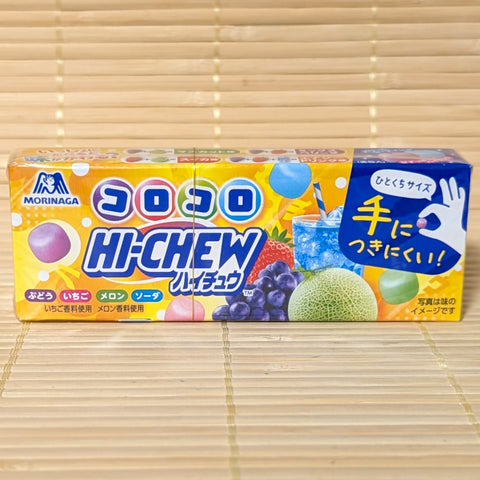 A colorful 40g box of Hi-Chew Mini Koro Koro showing grape, strawberry, melon, and soda graphics on a bamboo background.