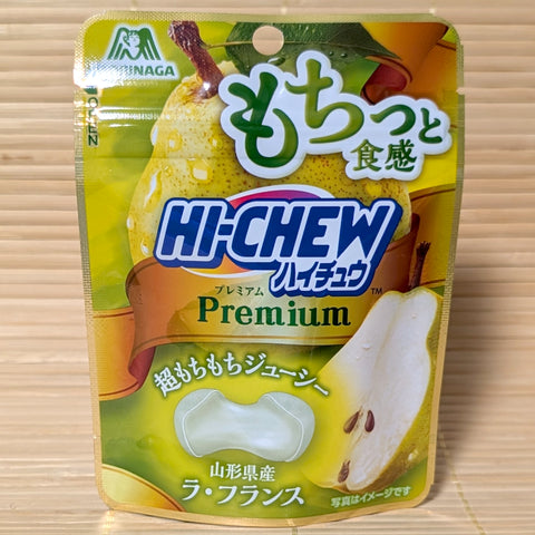 A 32g standing pouch of Morinaga Hi-Chew Premium La France Pear chews with Yamagata pear graphics, resting on a bamboo mat.