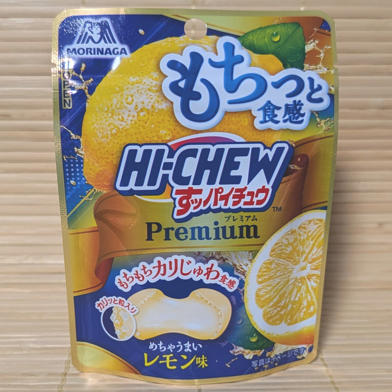 A blue and yellow pouch of Morinaga Hi-Chew Premium Lemon ball-shaped candies displayed on a tatami background.
